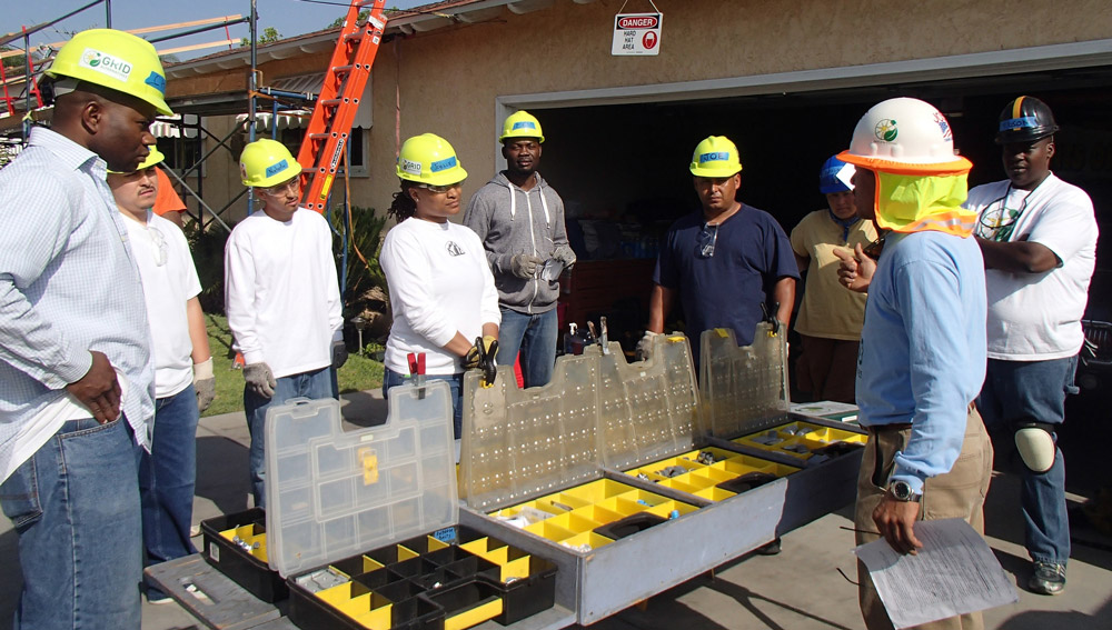 a group of people wearing hardhats and standing in a room